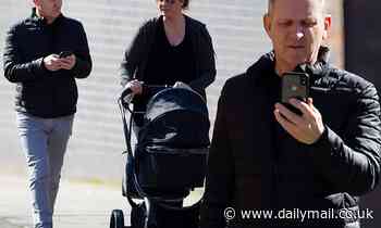 Jeremy Kyle, 54, enjoys a family stroll with his baby son and fiancée Vicky Burton, 37, in Windsor