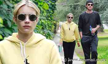 Emma Roberts dons sweatpants and a yellow hoodie for casual LA stroll with beau Garrett Hedlund 