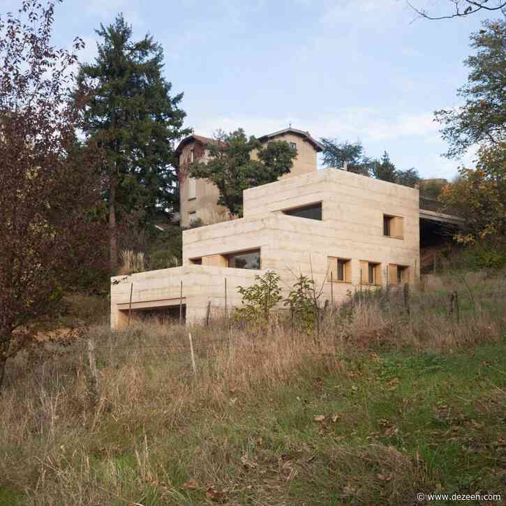 Tectoniques sets ochre-coloured concrete house into French hillside