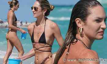 Candice Swanepoel sports a tiny bikini and looks carefree with her sons at the beach in Miami