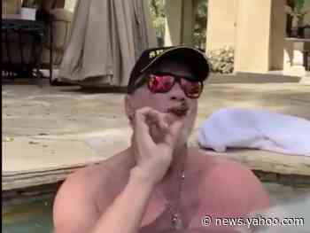 Arnold Schwarzenegger tells world to practice social distancing, while smoking cigar in hot tub