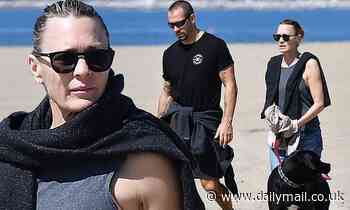 Robin Wright and Clement Giraudet take their dog to the beach as LA cracks down on public gatherings