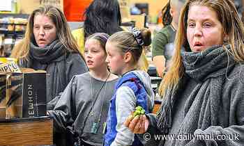 Lisa Marie Presley stays toasty in a charcoal fleece as she makes a grocery run with her daughters