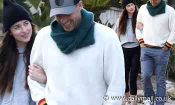 Dakota Johnson and Chris Martin take a self-isolation break as they walk arm-in-arm in Malibu