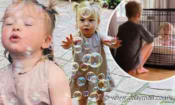 Hilary Duff's daughter Banks, one, blows bubbles before brother Luca, eight, locks her in dog crate