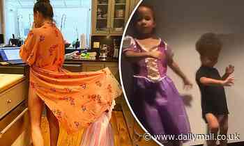 Chrissy Teigen shares hilarious snap of daughter Luna playing under her robe as she tries to work
