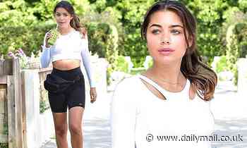 Hannah Ann Sluss flashes her toned midriff in a cute white top on an outing in Beverly Hills