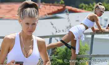 Charlotte McKinney works out in public as she walks with a strap around her legs