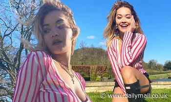Rita Ora showcases her toned physique in striped top and dark shorts as she poses alone in field