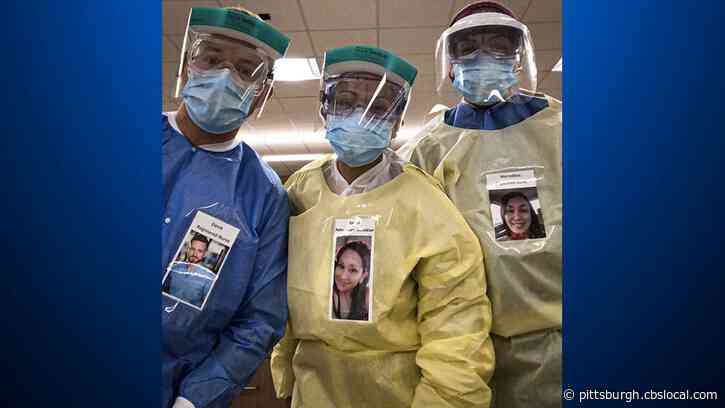 Health Care Workers Are Wearing Smiling Photos Of Themselves To Put Coronavirus Patients At Ease