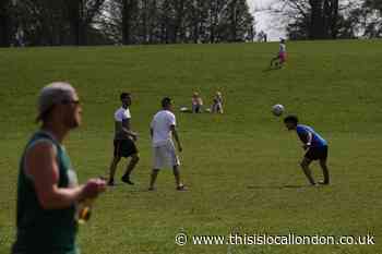 People at Lewisham Park to soak up heat despite lockdown