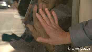 Families looking to connect with loved ones in nursing homes perfect the 'window visit'