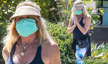 Goldie Hawn enjoys the sunshine wearing face mask and visor