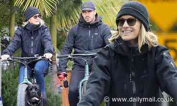Robin Wright beams while riding bikes with husband Clement Giraudet and their dog during quarantine