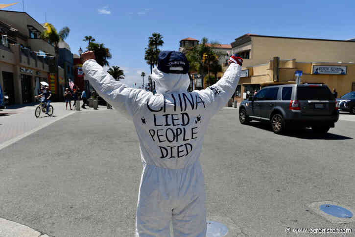 Dozens of protesters gather in Huntington Beach in defiance of stay-at-home orders