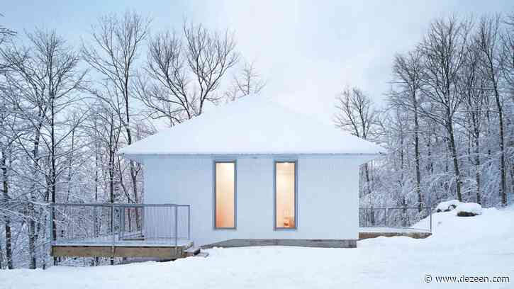 Poisson Blanc cabin by Naturehumaine has a white pointed metal roof