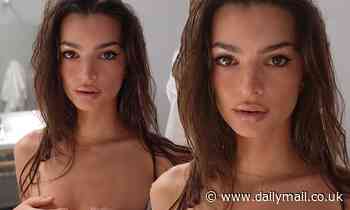 Emily Ratajkowski looks doe-eyed as she strips down for topless bathroom selfie