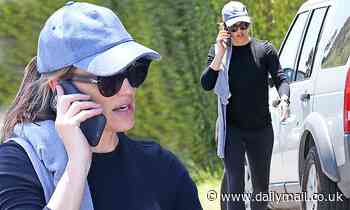 Jennifer Garner pulls off her face mask to chat on her cell phone after a power walk