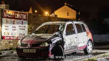 Three teenagers arrested after car burnt out in west Belfast