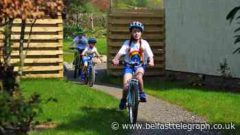 Three young siblings cycle marathon in garden to raise money for NHS