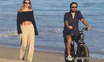 Sofia Richie flashes her toned abs as she enjoys a sunset beach stroll with Scott Disick in Malibu