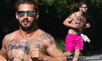 Shia LaBeouf revealed his heavily tattoo torso as he goes shirtless for a run in hot pink shorts - Daily Mail