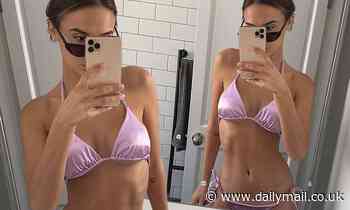 Lucy Watson showcases her taut abs in a lilac bikini as she poses for a sizzling selfie