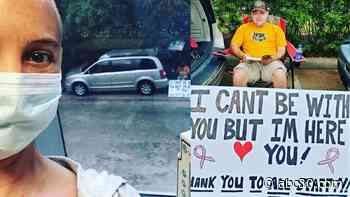 Man creates sign and sits outside hospital to support wife during her chemo treatment