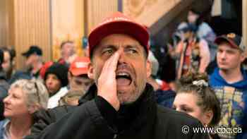 Armed people in Michigan's legislature protest proposed coronavirus restrictions extension