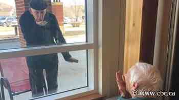 'Do you know I love you?': Winnipeg couple of 70 years 'connect' through window amid COVID-19 restrictions