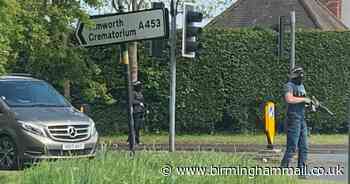 Armed cops wield huge guns in daylight drama at traffic lights