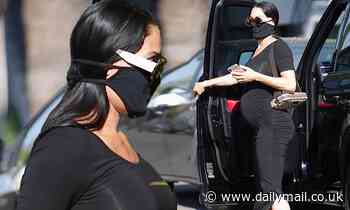 Nikki Bella shows off every curve including her big baby bump in a black bodycon maternity dress