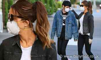 Kate Beckinsale, 46, looks smitten with new toyboy Goody Grace, 22, as she adjusts his mask