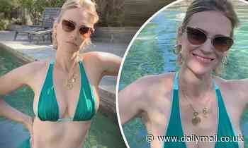 January Jones sends a cheeky message as she flashes her cleavage in TINY blue bikini