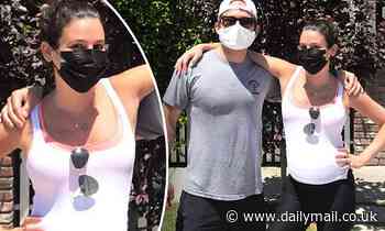 Lea Michele shows a hint of her baby bump in a white tank top as she poses with husband Zandy Reich