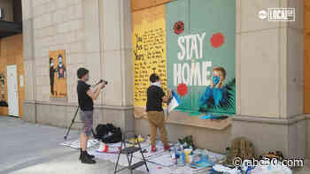 Boarded up storefront becomes canvas for street artists
