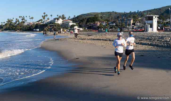 Beachgoers celebrate opening in Laguna and San Clemente, with limited-use only