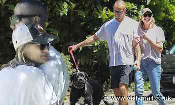 Robin Wright and husband Clement Giraudet pack on the PDA during a trip to the dog park 