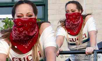 Mariah Carey dons a bandana as a mask while cheering on essential workers from her NYC penthouse