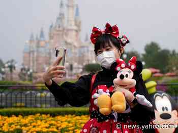 Check out these wild photos of Disneyland's sold-out reopening in China — complete with temperature checks, mandatory face masks, and yellow social-distancing boxes