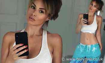 Rhian Sugden flashes cleavage and toned abs in a grey crop top
