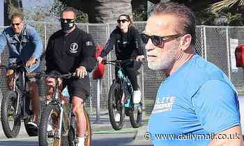Arnold Schwarzenegger wears his 'we'll be back mask' on bike ride with daughter Christina