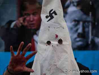 Colorado police are looking for a man seen at a grocery story wearing a KKK hood with a swastika