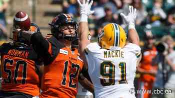 Edmonton Eskimos football player trades shoulder pads for hospital scrubs