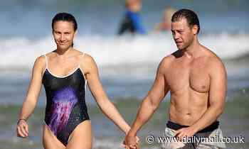 Rachael Finch hits the beach in a high-cut swimsuit
