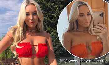 TOWIE's Amber Turner wows in strapless red bikini as she enjoys a sunbathing session on her balcony 