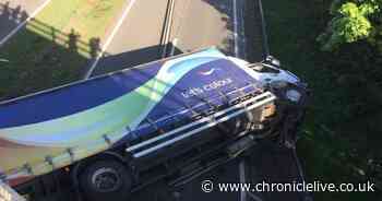 Dulux lorry crashes through central barrier on A19 and overturns