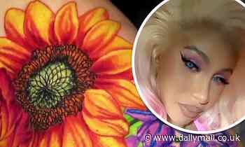 Cardi B unveils her entire back tattoo with bright pink flowers and a butterfly