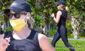 Reese Witherspoon wears a mask to jog around her exclusive LA neighborhood