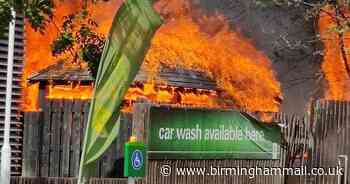 Firefighters tackle blaze next to petrol station